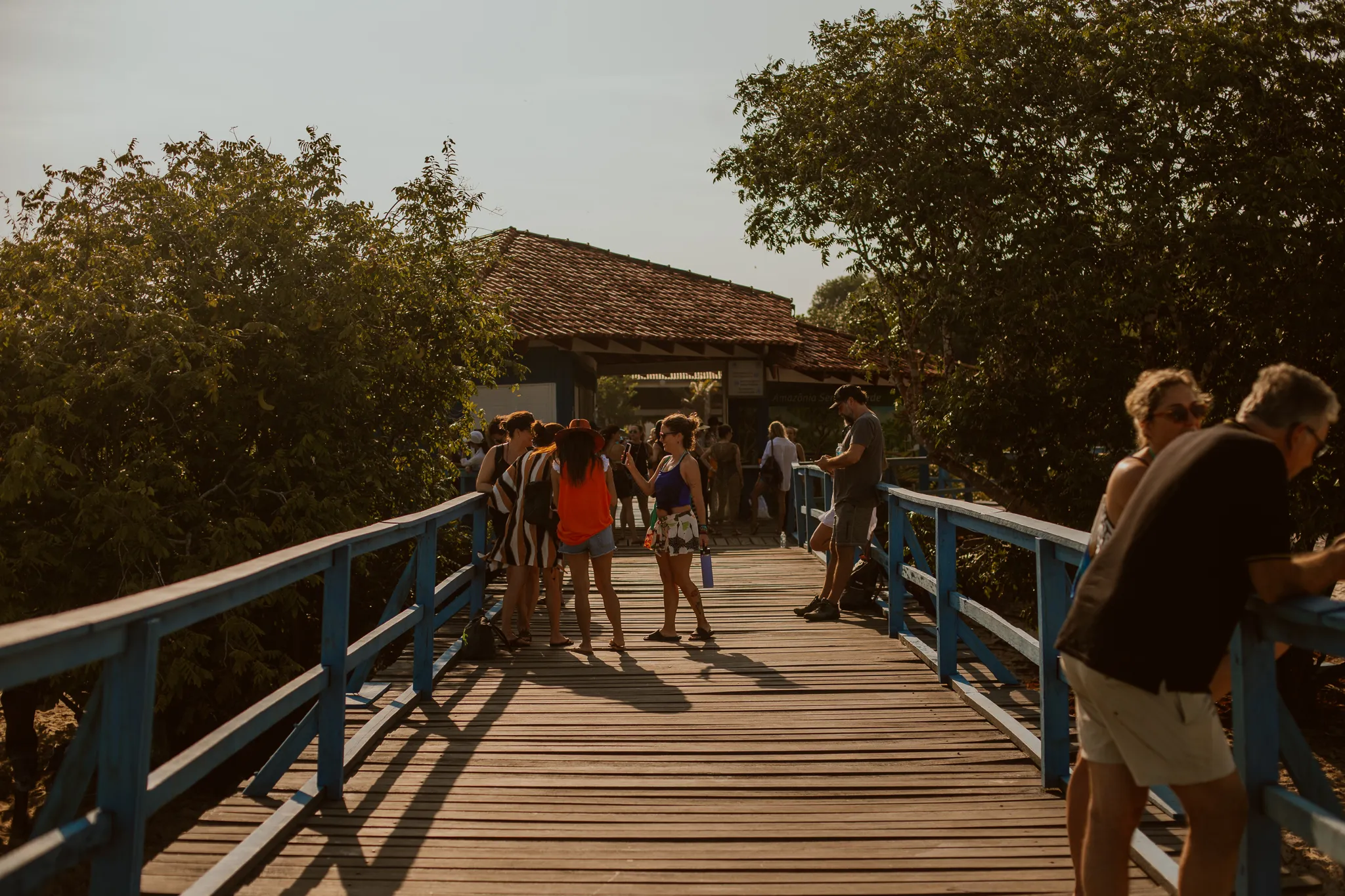 A group of guests walking along the blue wooden walkway in Alter do Chão, on their way to board